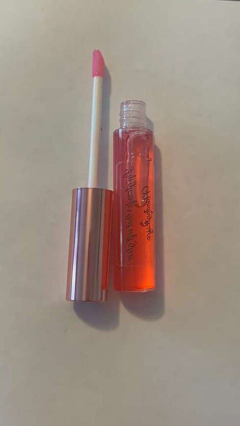 Lip gloss and lip liner on a light surface